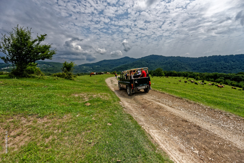 Off-road mountain tour through the canyons of the Psaho river, Sochi, Russia. Off-road car with passengers is going to the mountains.
