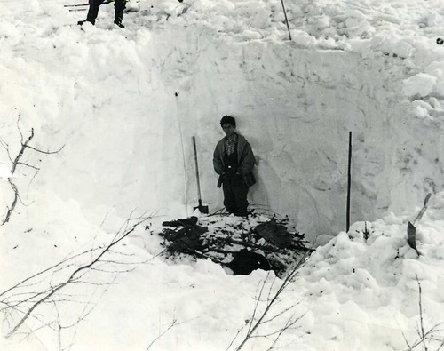 Search party in snow ditch.